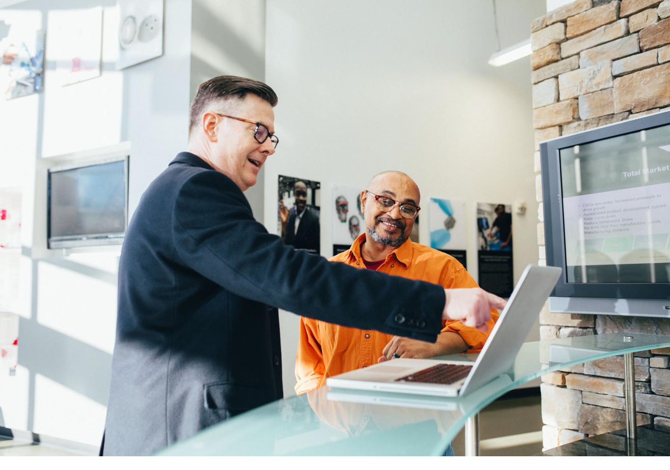 Two business professionals having a calm working conversation with planning materials between them