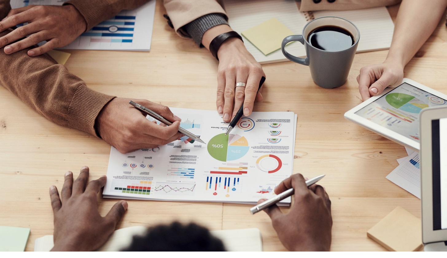 A team comparing several data views during a market review